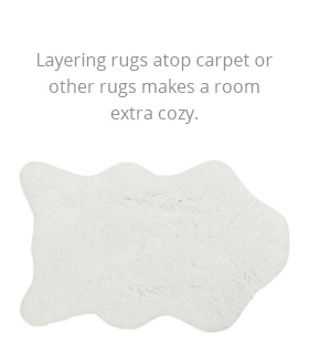 Layering rugs atop carper or toehr rugs makes a room extra cozy. Sheepskin fur throw rug